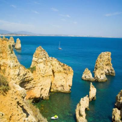 Praia com falésias gigantes em mar azul é atração no sul de Portugal